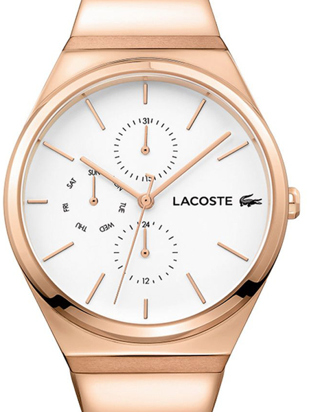 Rund vit urtavla med roséguldfärgade detaljer och Lacoste-logotyp. Tre suburtavlor synliga.