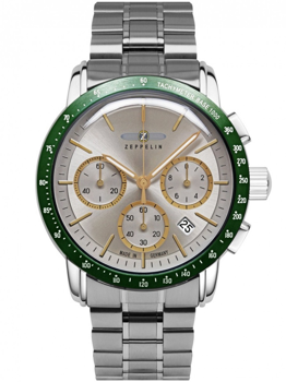 Klocka med grön bezel, tre sub-dials, datum vid fyra, och text "TACHYMETER BASE 1000".